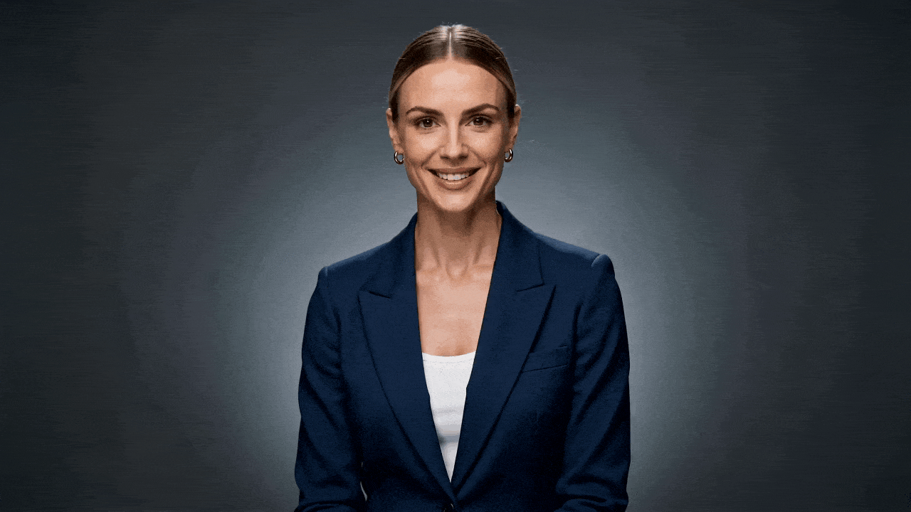 Prompt: Medium-close-up: A confident 30-year-old woman in a navy blazer smiles warmly in soft studio lighting. [Audio-Visual Sync] She looks at the camera and says clearly: 'Welcome to the future of creative production.' Her lip-sync and expressions must perfectly match her warm voice. [Camera Control] Slow, continuous zoom in. 1080p.