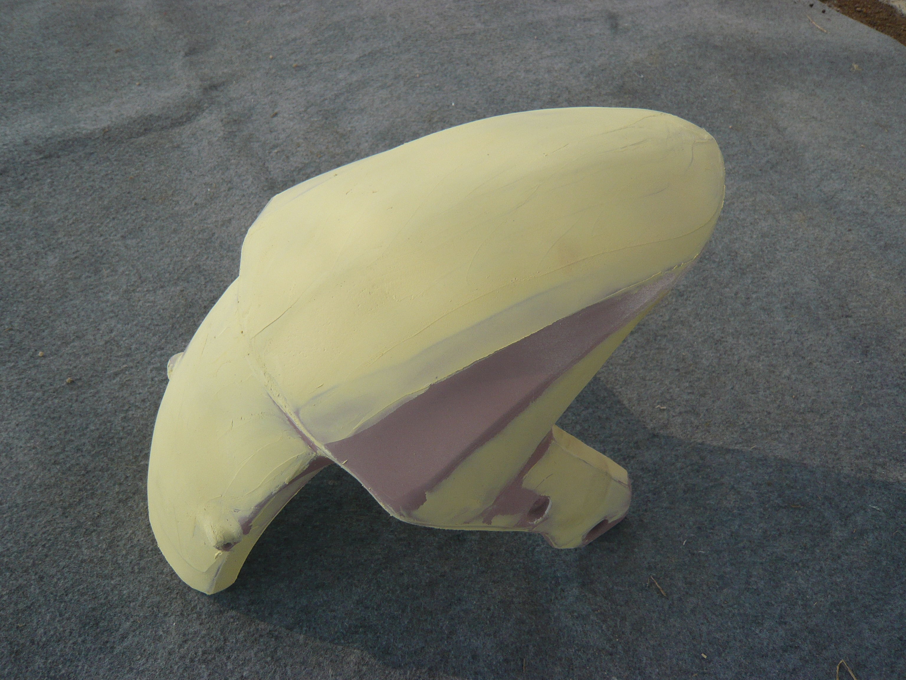 Unpainted front fender during surface preparation in the NiceFairings workshop.