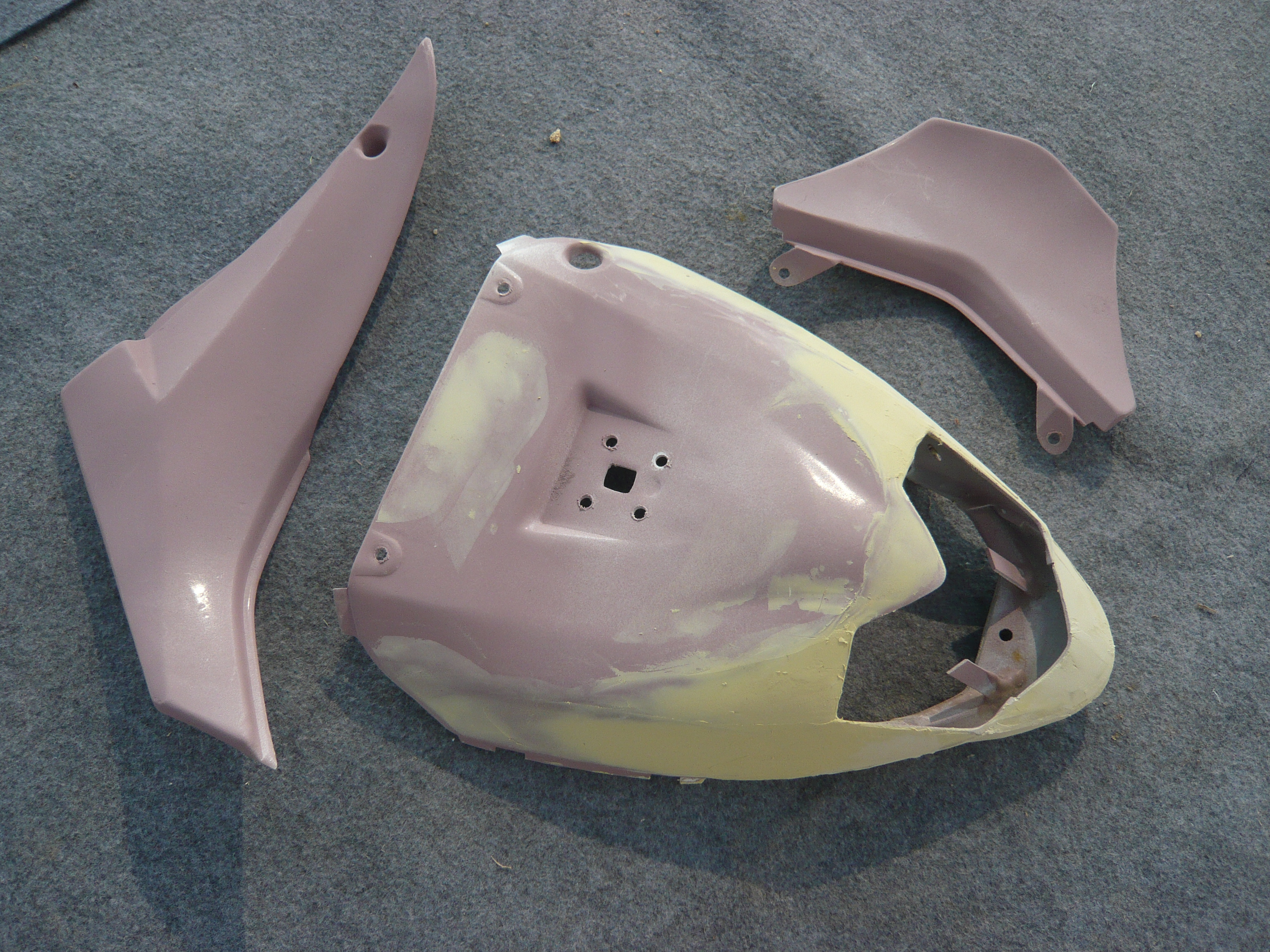 Unpainted tail fairing panels during surface preparation in the NiceFairings workshop.