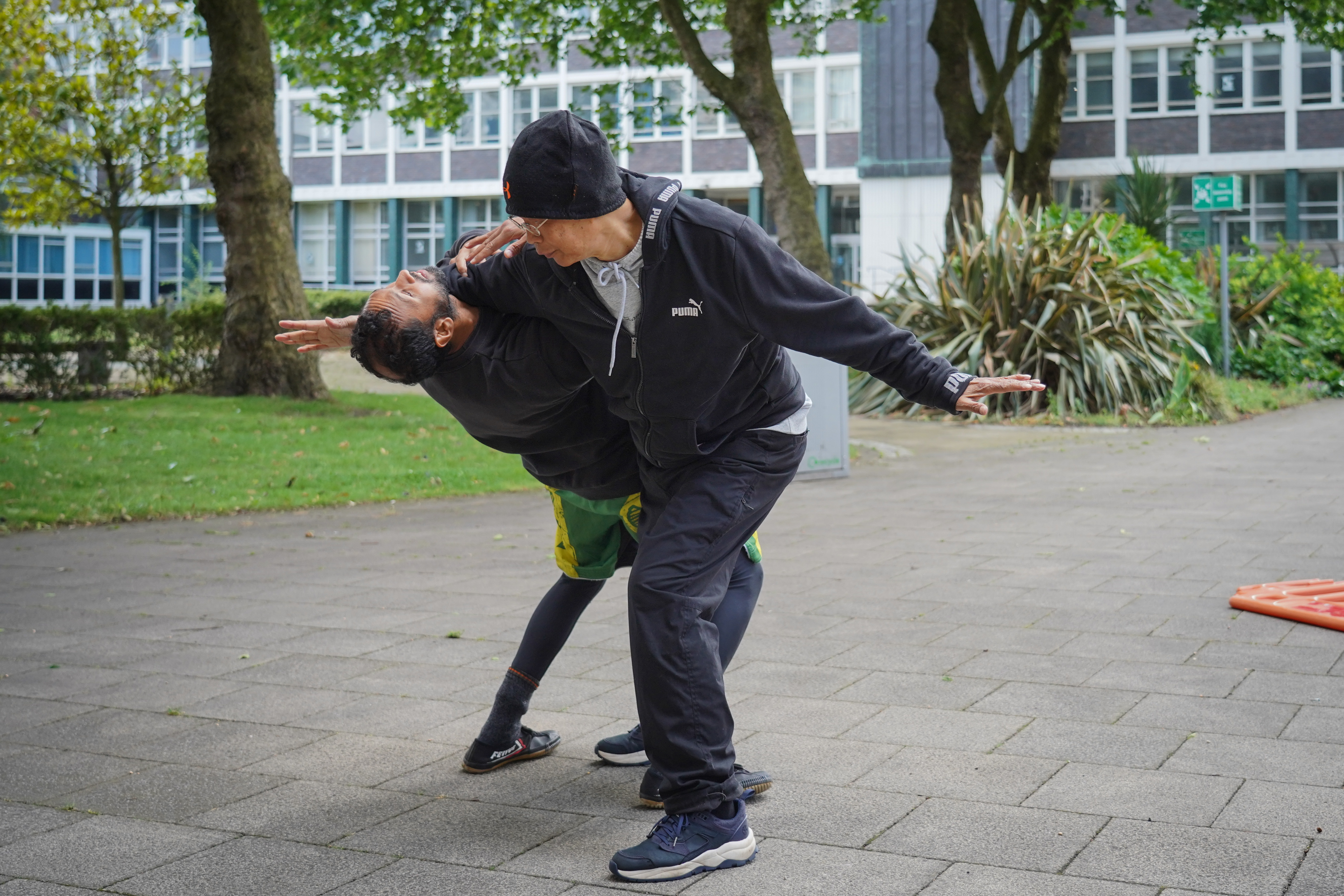 People practicing Tai Chi in a serene natural setting