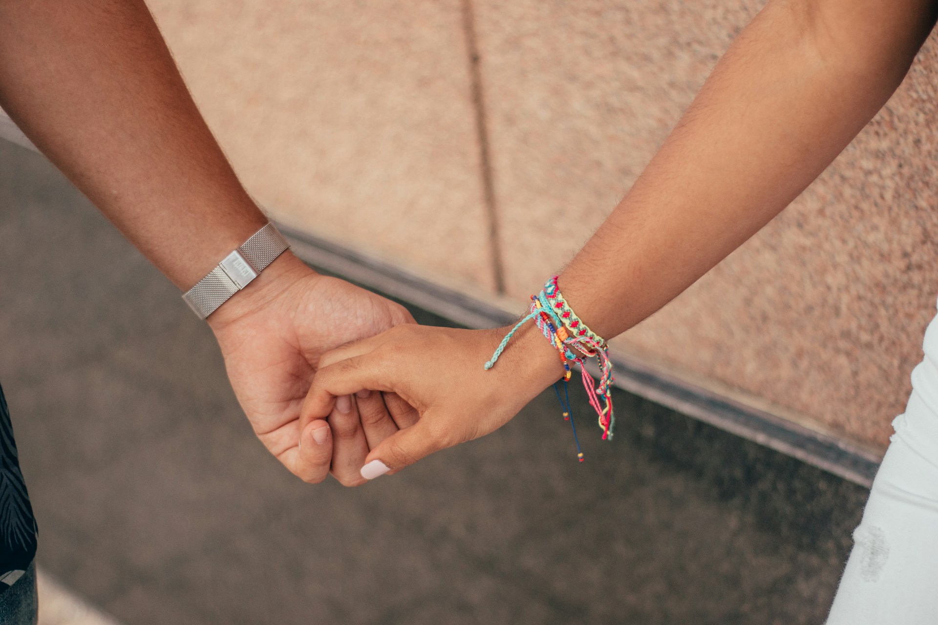 Hands holding each other in support, symbolizing healthy connection and trust
