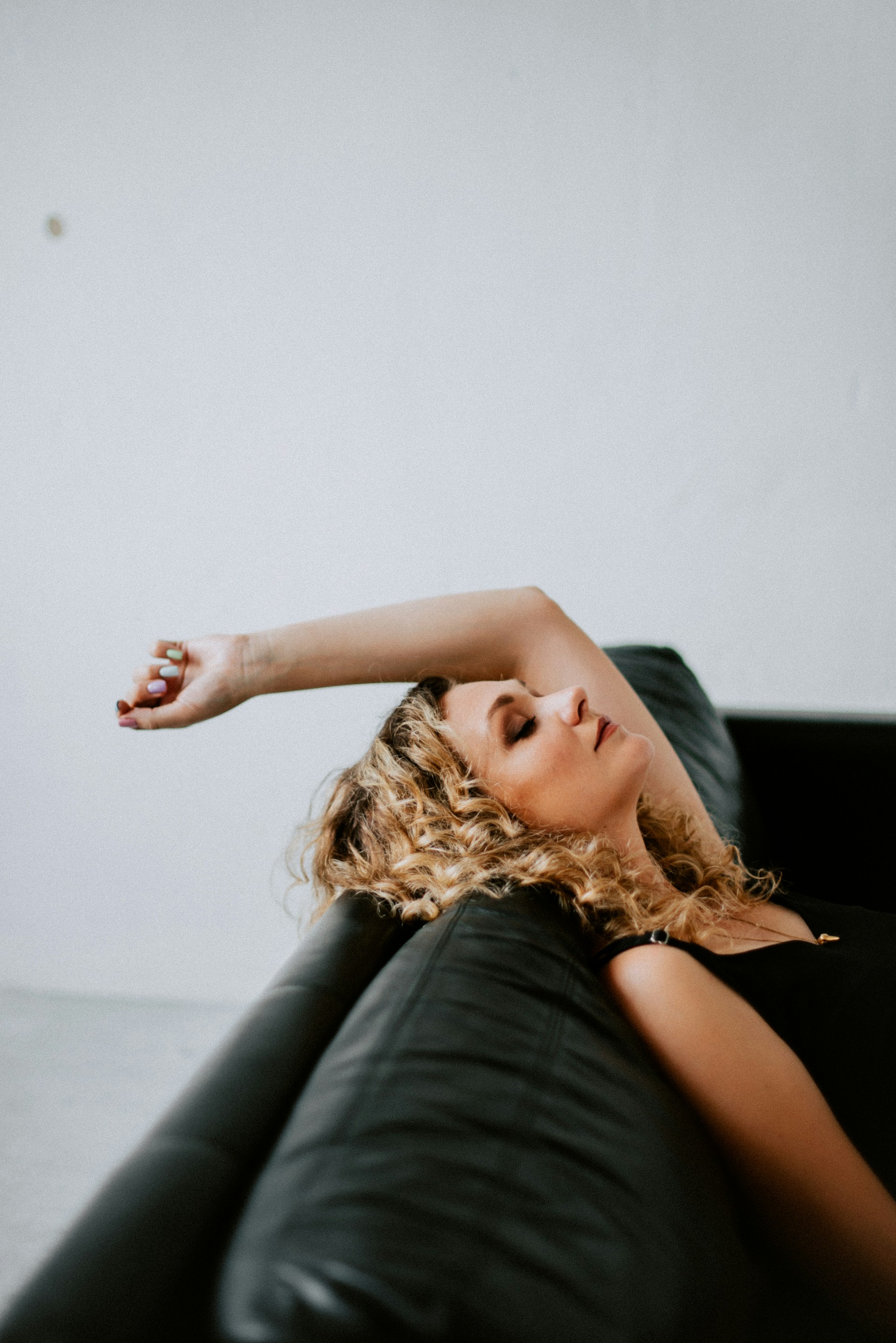Person sitting on the coach in contemplative pose, representing healing and recovery