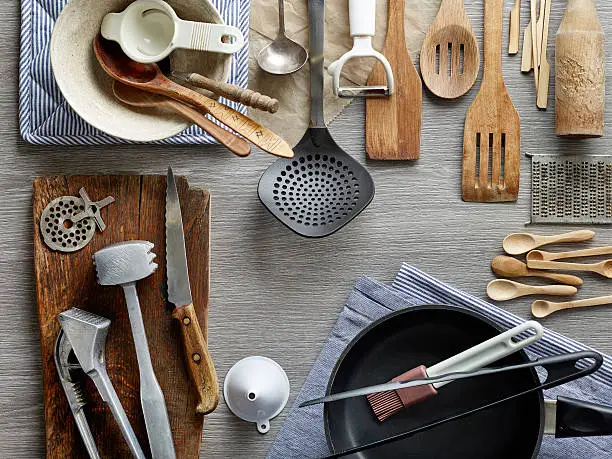 Different types of kitchen utensils are placed on the table