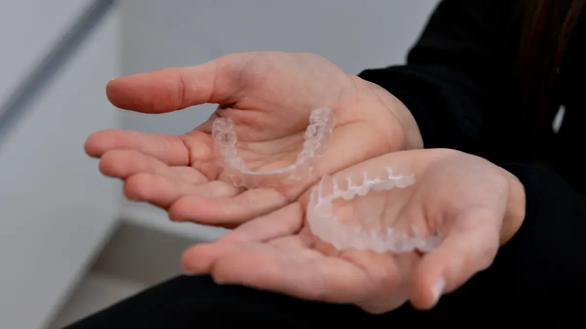 Which manufacturers offer clear aligners and retainers under one supply program