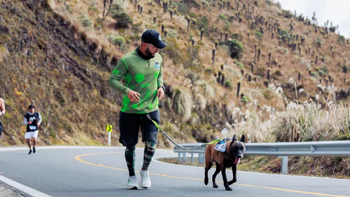 Trail runner with dog using reflective leash on mixed-use path
