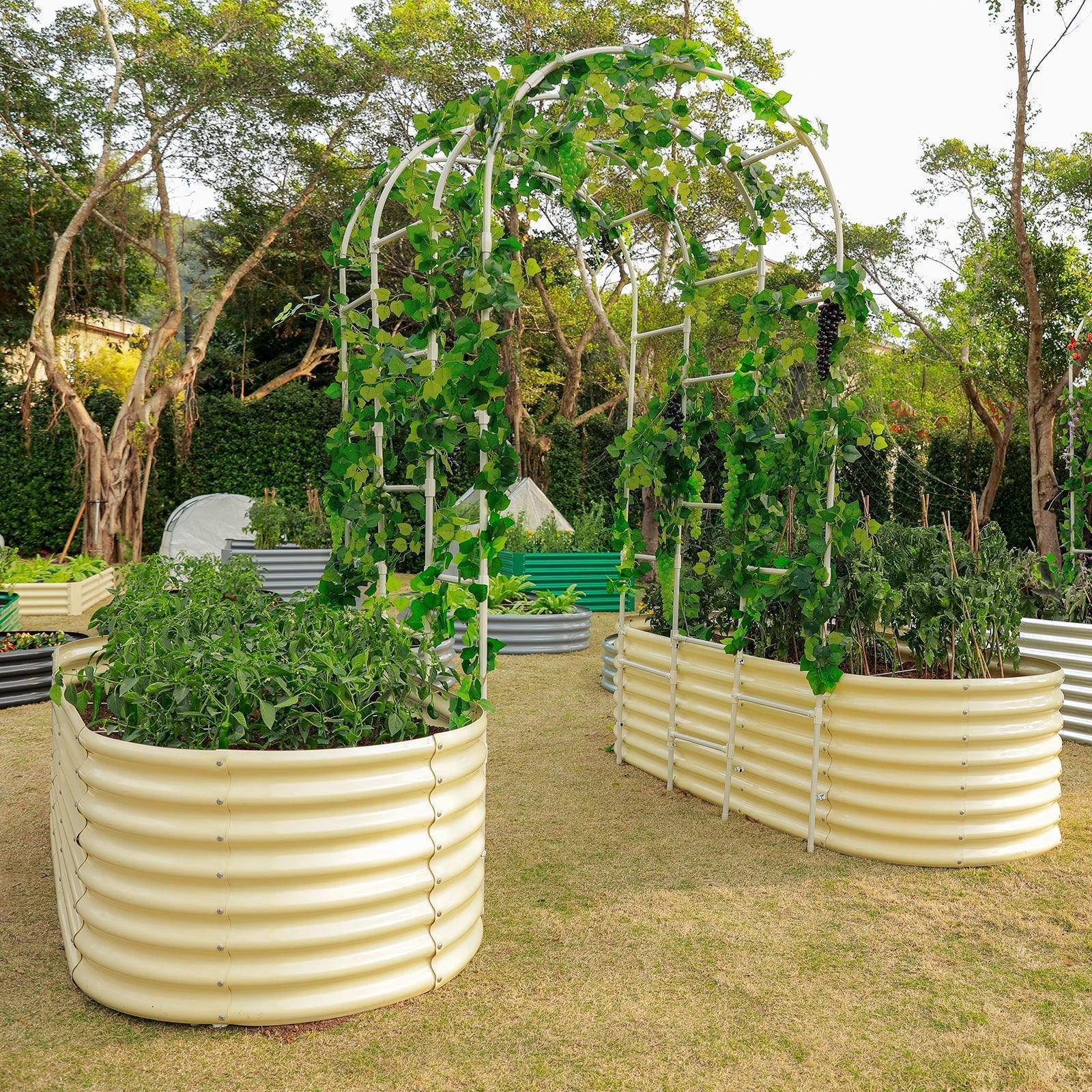 A garden with various corrugated metal raised beds, including two U-shaped beds connected by a vine-covered arch trellis.