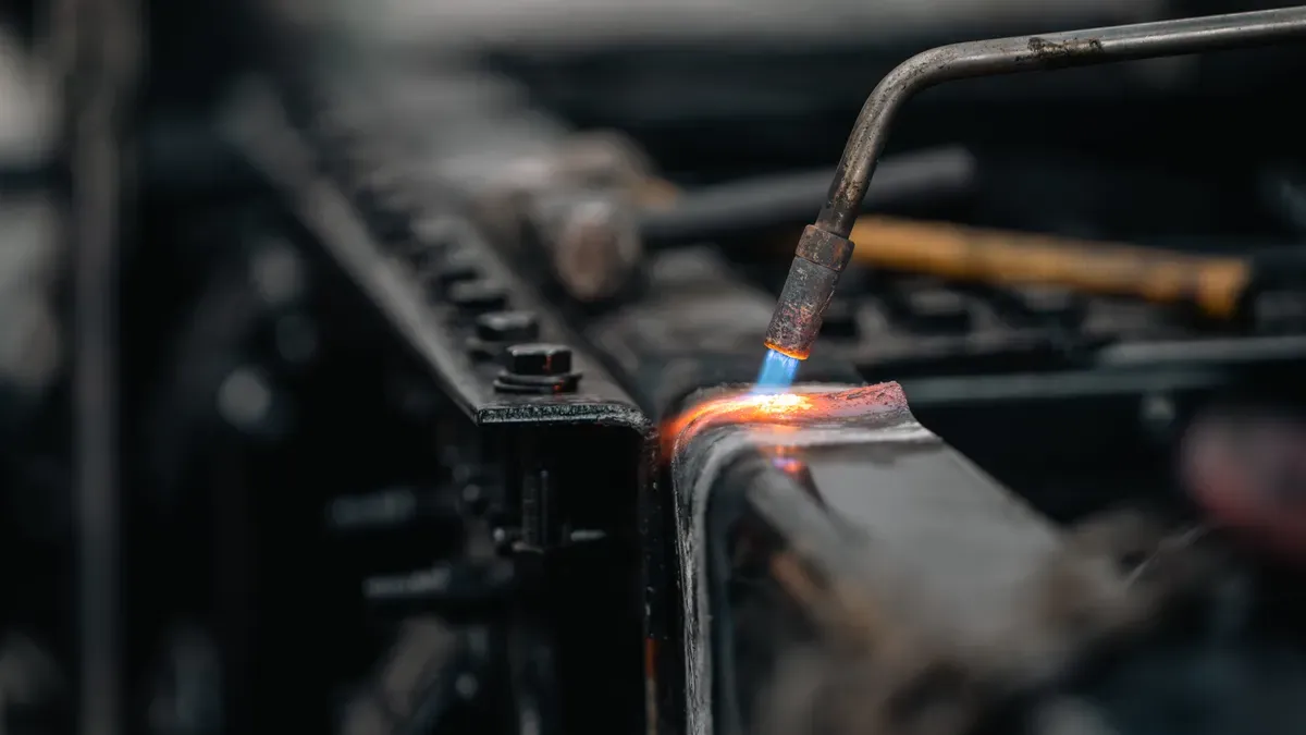 MIG welding in progress with blue arc and sparks
