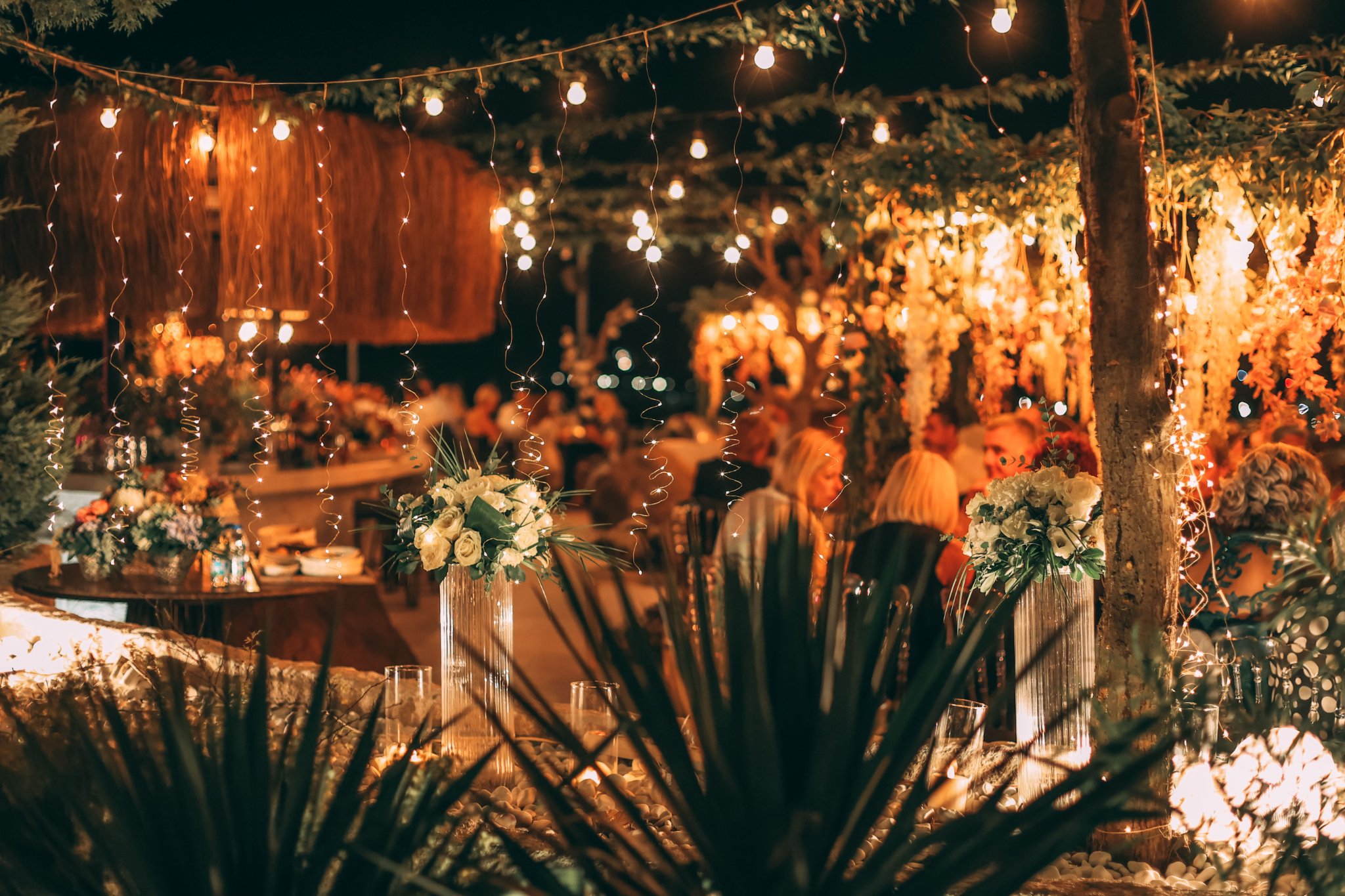 Outdoor wedding ceremony with string lights