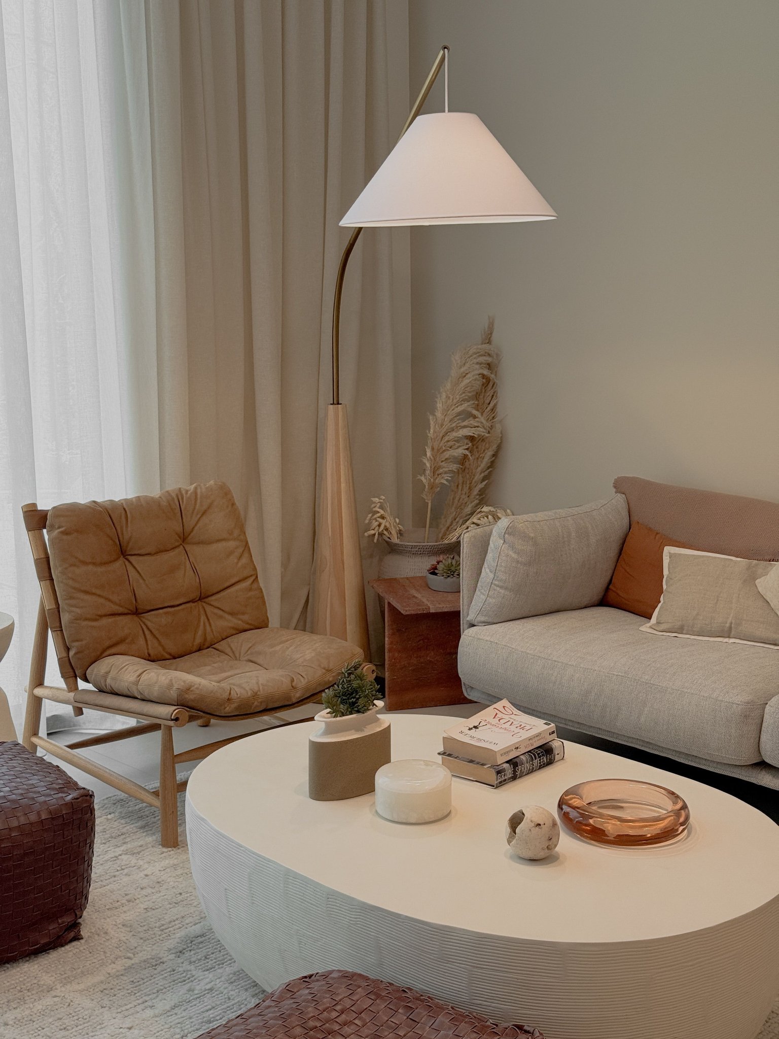 Arched floor lamp used in a cozy interior setting.