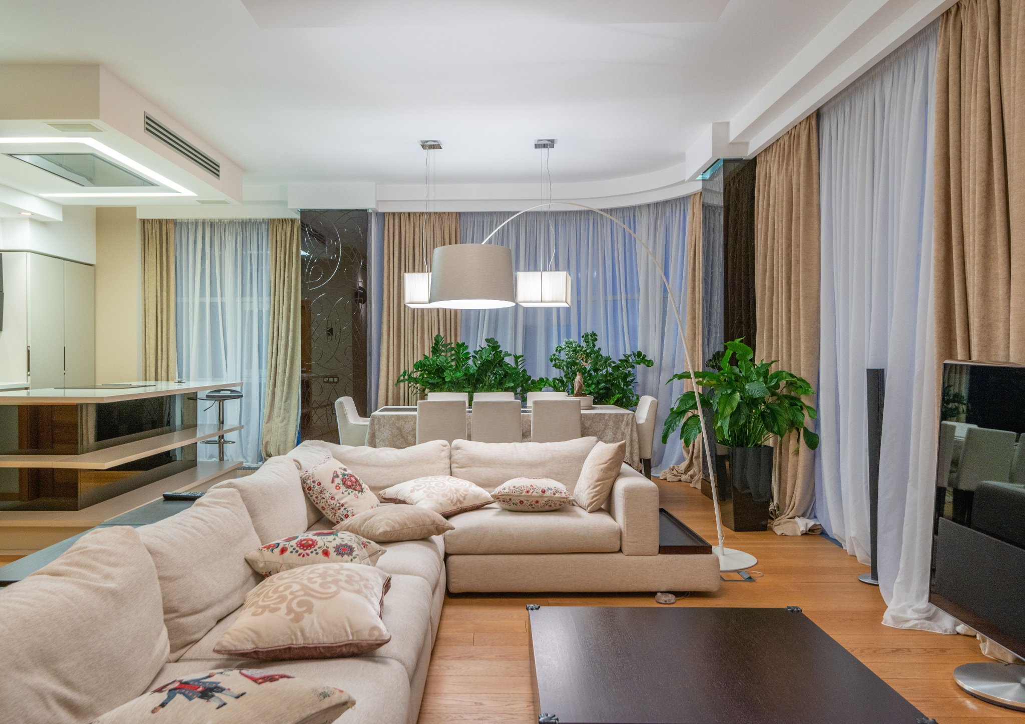 Interior space using layered lighting with floor lamps and ambient illumination