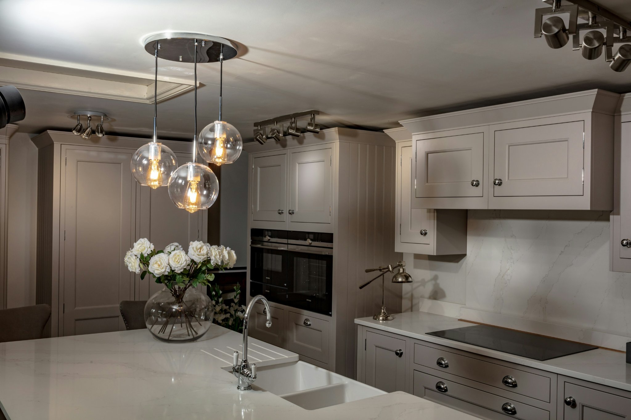 Modern kitchen island with pendant lights installed at balanced height above countertop