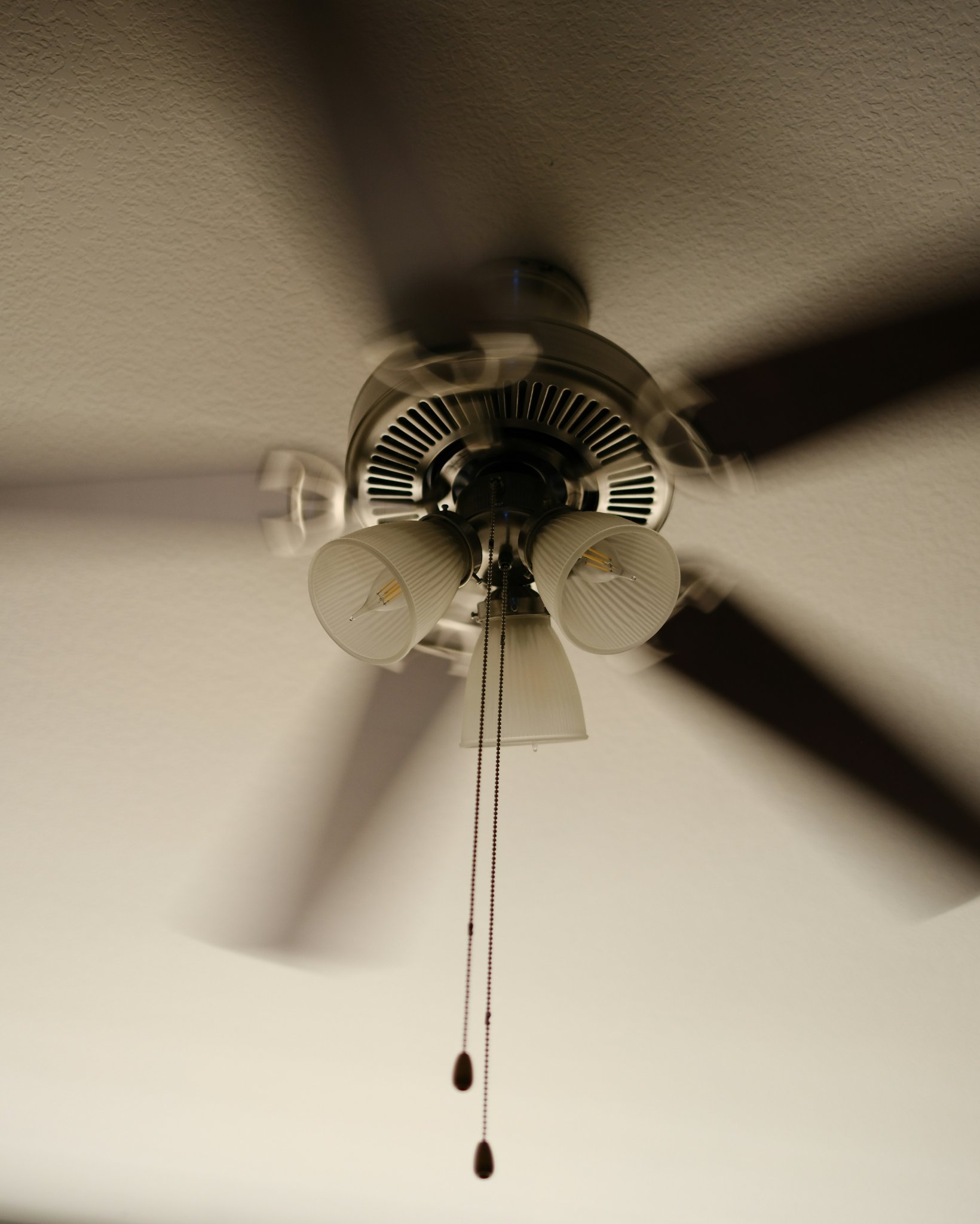 Modern ceiling fan circulating warm air in a living room during winter
