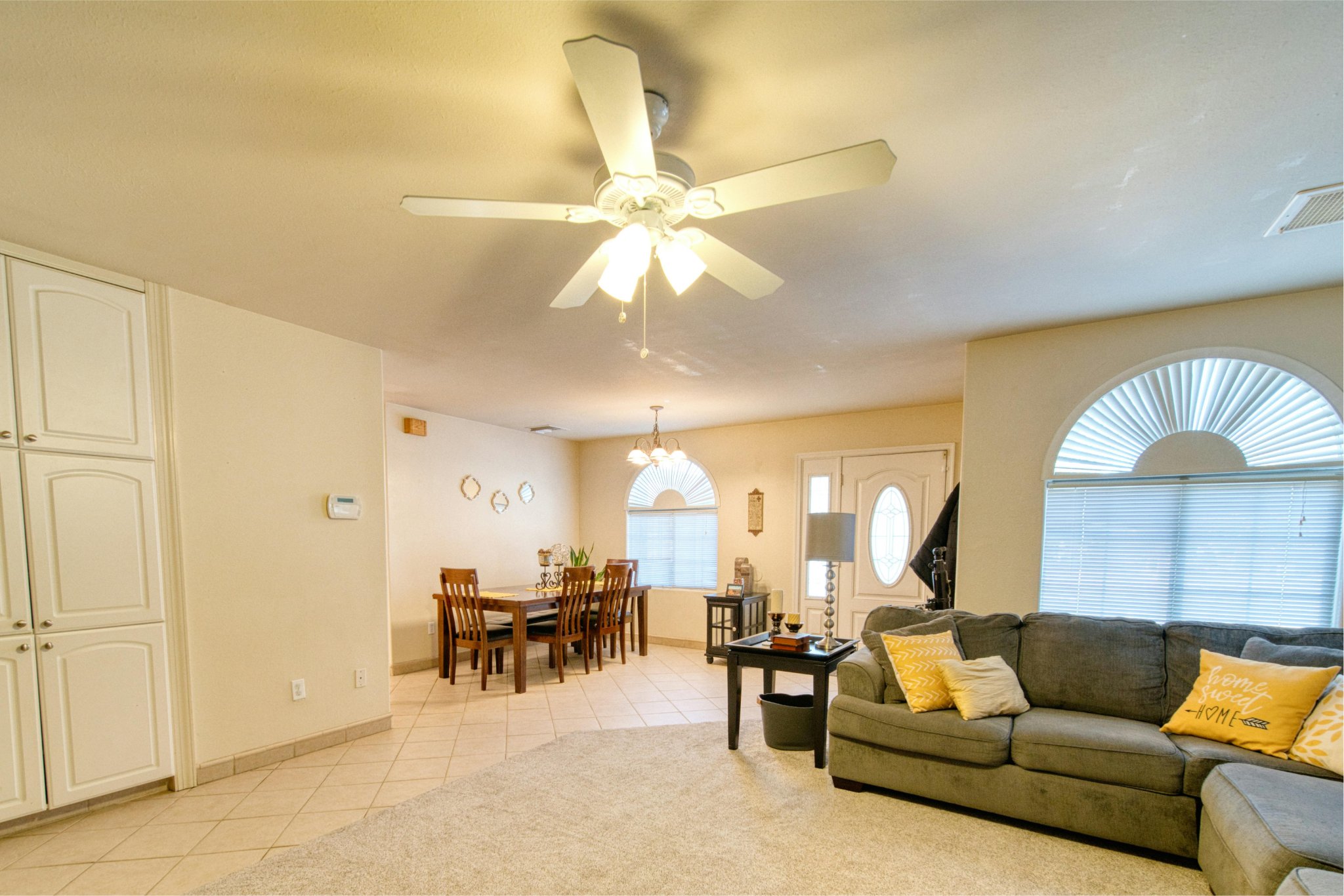 Modern living room featuring a stylish ceiling fan with light and contemporary interior design