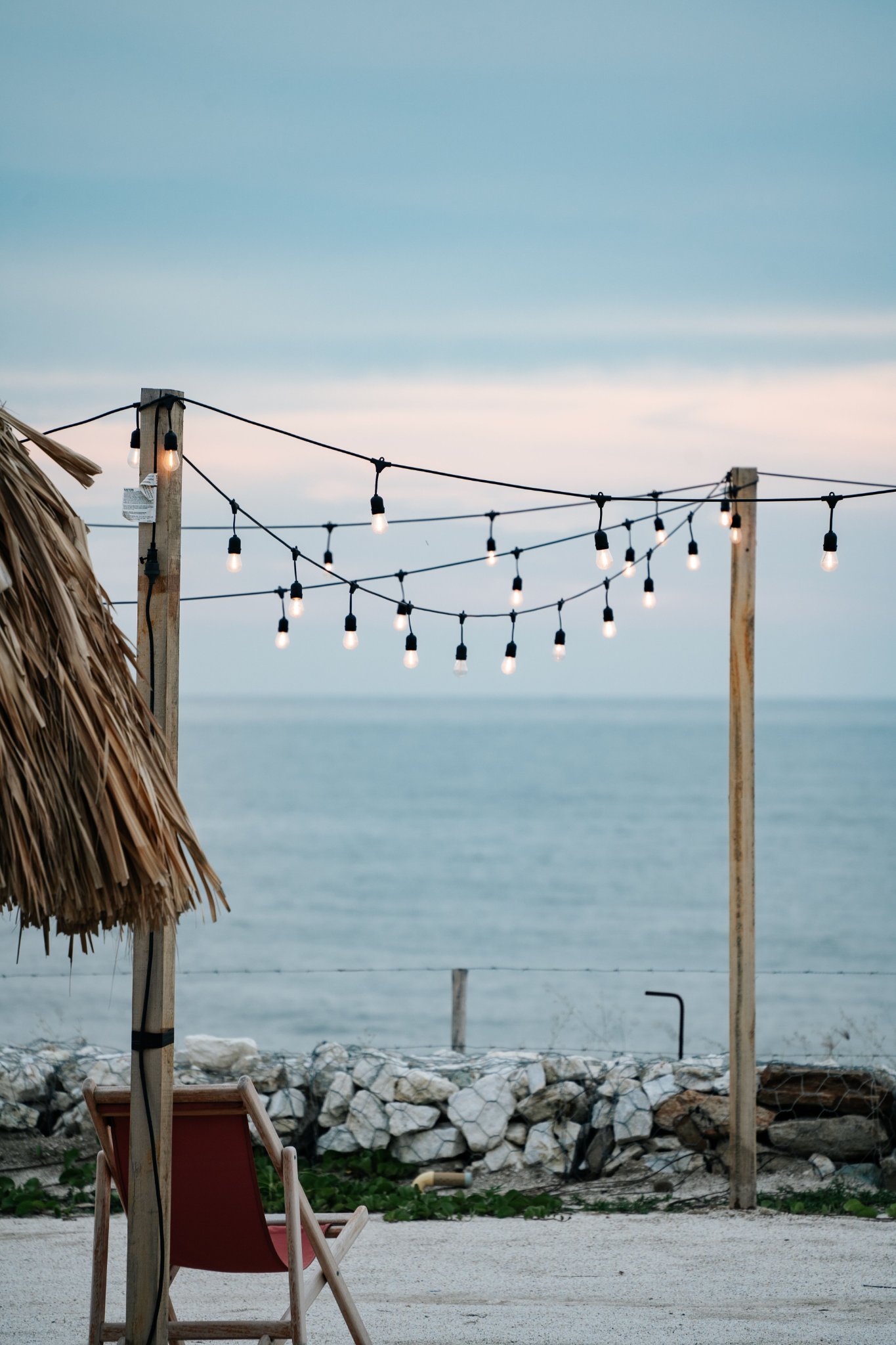Cozy outdoor seaside patio with string lights 
