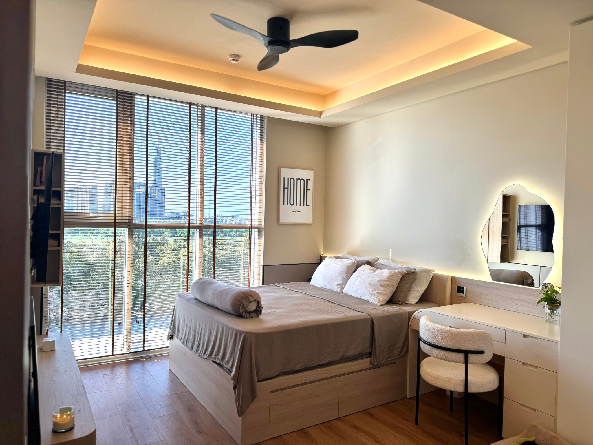 Scandinavian bedroom with a modern ceiling fan with light, wooden furniture, and warm ambient lighting